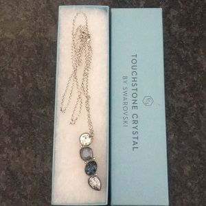 Touchstone Crystal by Swarovski. Necklace in blues and crystal colored pendant